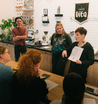 Caffe Vita trainers and educators teaching a public class on how to pull a shot of espresso.
