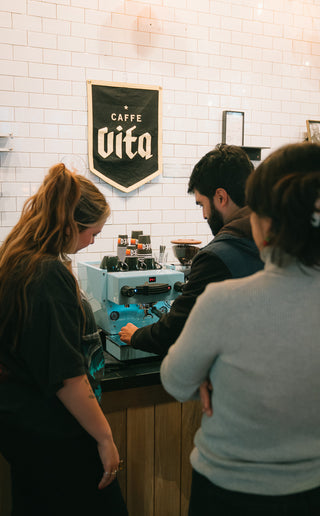 Caffe Vita trainers and educators teaching a public class on how to use an espresso machine.